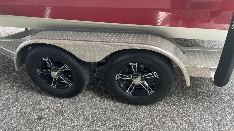 Slide: The Image of 2023 Excel 220 Bay Pro boat trailer with dual black alloy wheels. - 26