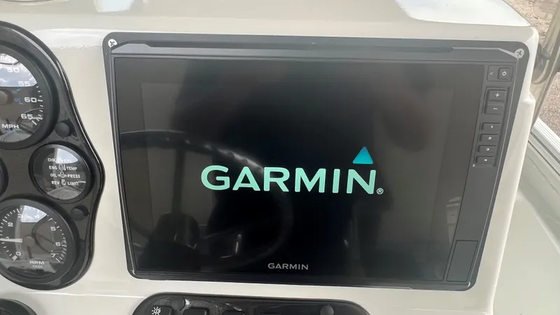 Slide: The Image of Garmin display and gauges on 2023 Excel 220 Bay Pro boat dashboard. - 7