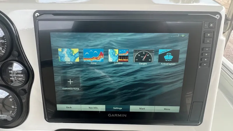 Slide: The Image of Garmin marine navigation display on 2023 Excel 220 Bay Pro boat showing charts, sonar, and gauges. - 8