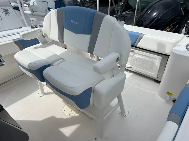 Slide: The Image of 2024 Robalo R230 Center Console boat seating area with cushioned seats. - 10