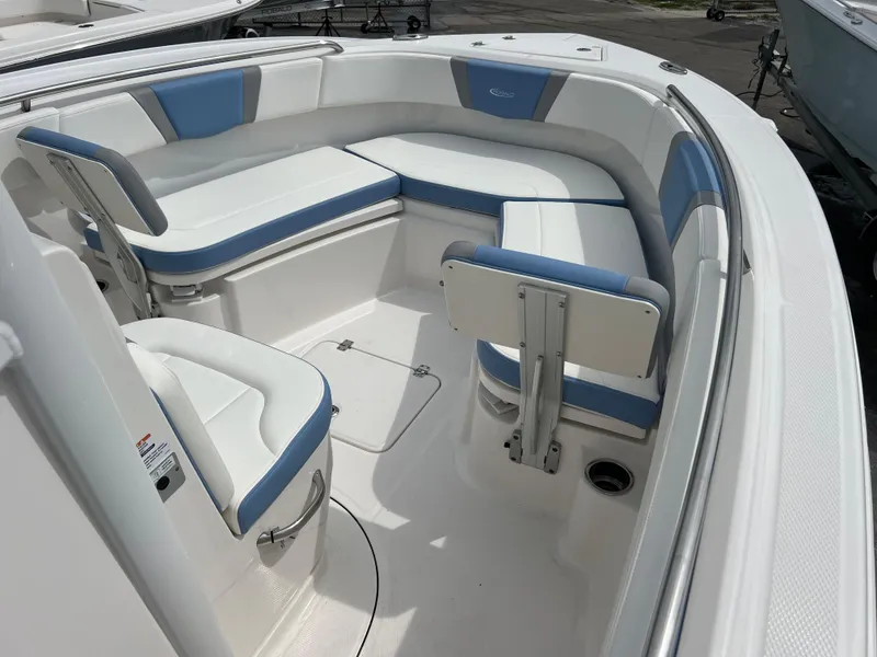 Slide: The Image of 2024 Robalo R230 Center Console boat with white and blue seating. - 7