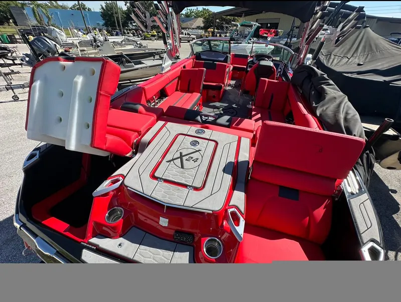 Slide: The Image of 2020 MasterCraft X24 boat with red and gray interior, spacious seating, and modern design. - 10