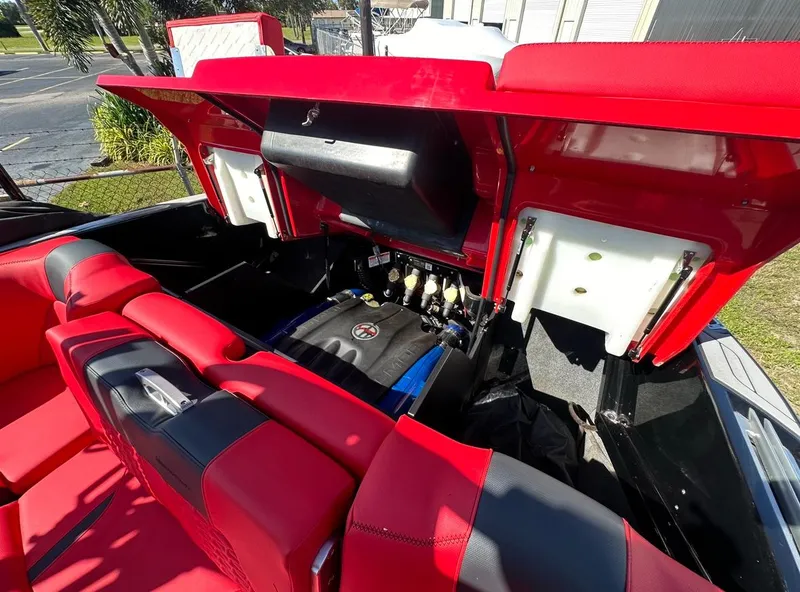 Slide: The Image of 2020 MasterCraft X24 boat engine compartment with red and black interior. - 13