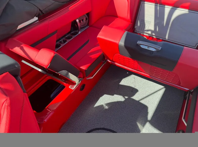 Slide: The Image of 2020 MasterCraft X24 boat interior with red and black seating and storage compartments. - 16