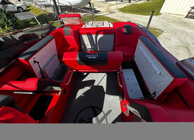 Slide: The Image of 2020 MasterCraft X24 boat interior with red seating and storage compartments. - 17