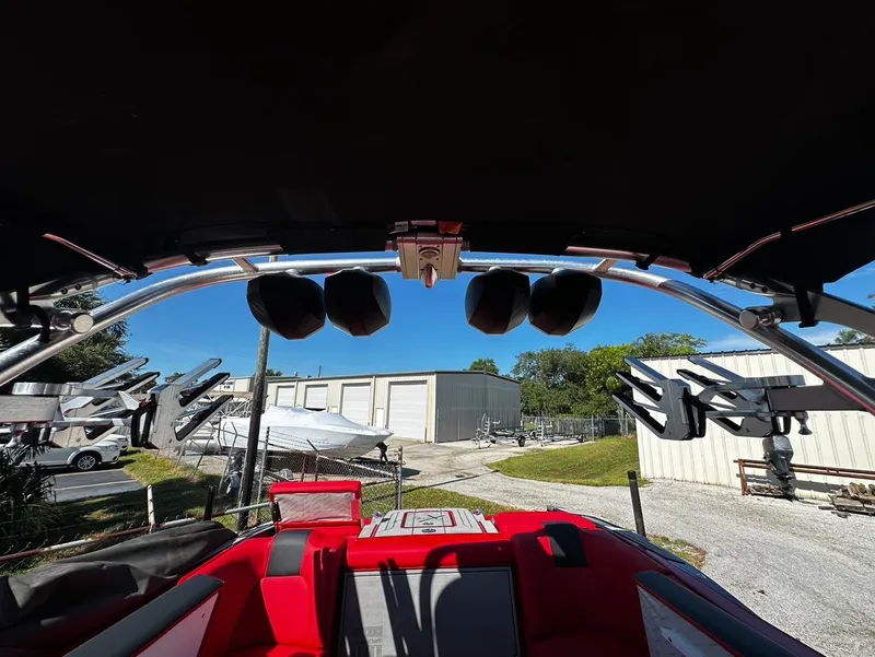 Slide: The Image of 2020 MasterCraft X24 boat with red interior and wakeboard tower. - 18