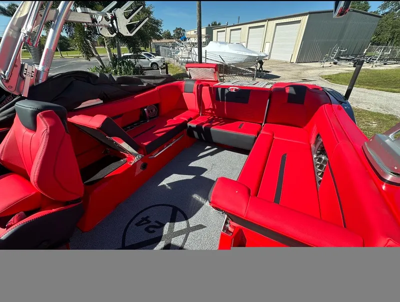 Slide: The Image of 2020 MasterCraft X24 boat with red interior seating and spacious layout. - 23