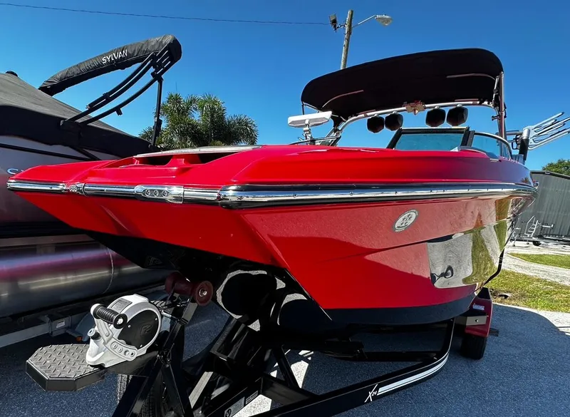 Slide: The Image of 2020 MasterCraft X24 red boat on trailer, side view. - 3