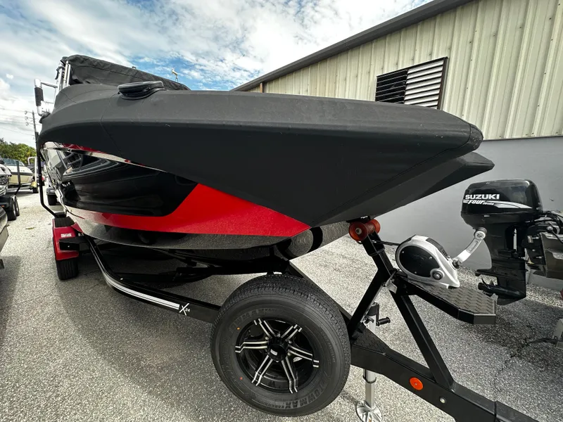 Slide: The Image of 2020 MasterCraft X24 boat with black and red hull on a trailer. - 5