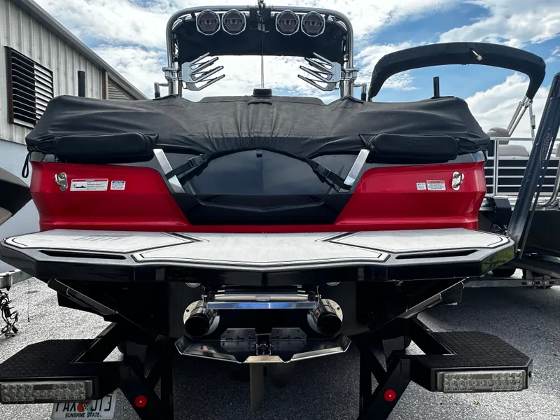 Slide: The Image of 2020 MasterCraft X24 boat rear view with cover, docked. - 6