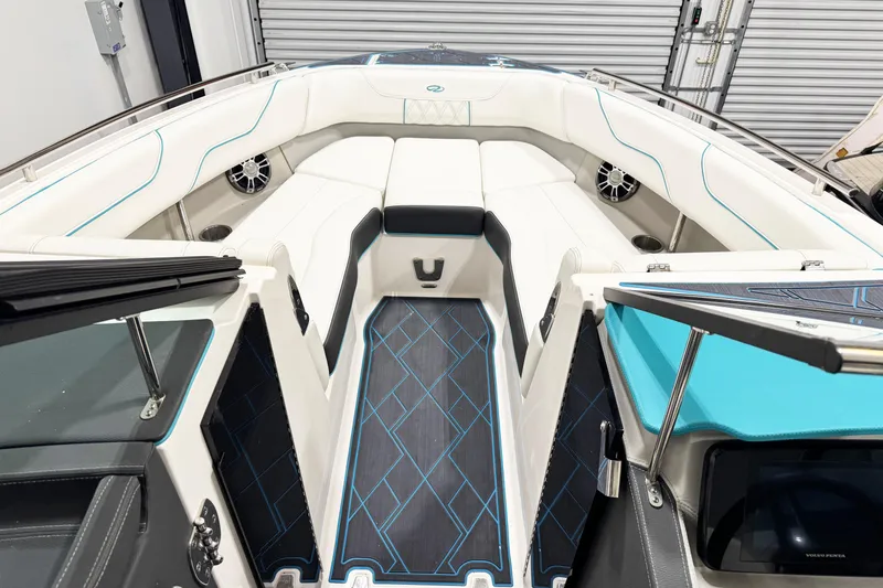 Slide: The Image of 2023 Regal LS6 boat interior with white seating, blue accents, and modern design. - 11