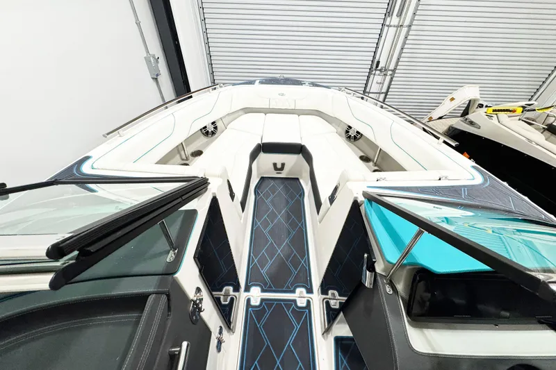 Slide: The Image of 2023 Regal LS6 boat interior with sleek seating and modern design in a showroom. - 12