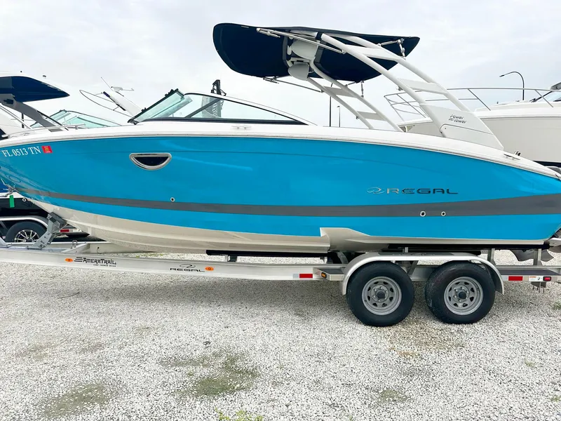 Slide: The Image of 2023 Regal LS6 boat on trailer, blue and white exterior. - 3