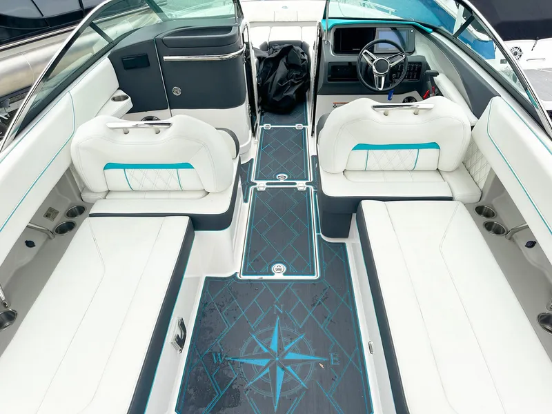 Slide: The Image of 2023 Regal LS6 boat interior with white seating and blue accents. - 5