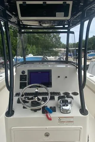 Slide: The Image of 2019 Sea Chaser 27 HFC CC boat console with steering wheel and navigation controls. - 4