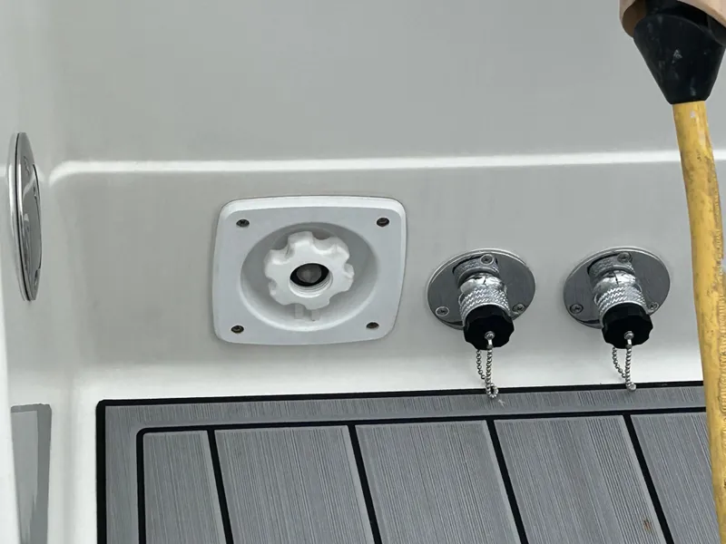 Slide: The Image of Boat deck fittings on a 2000 Formula 34 PC, featuring hose connections and a textured surface. - 11