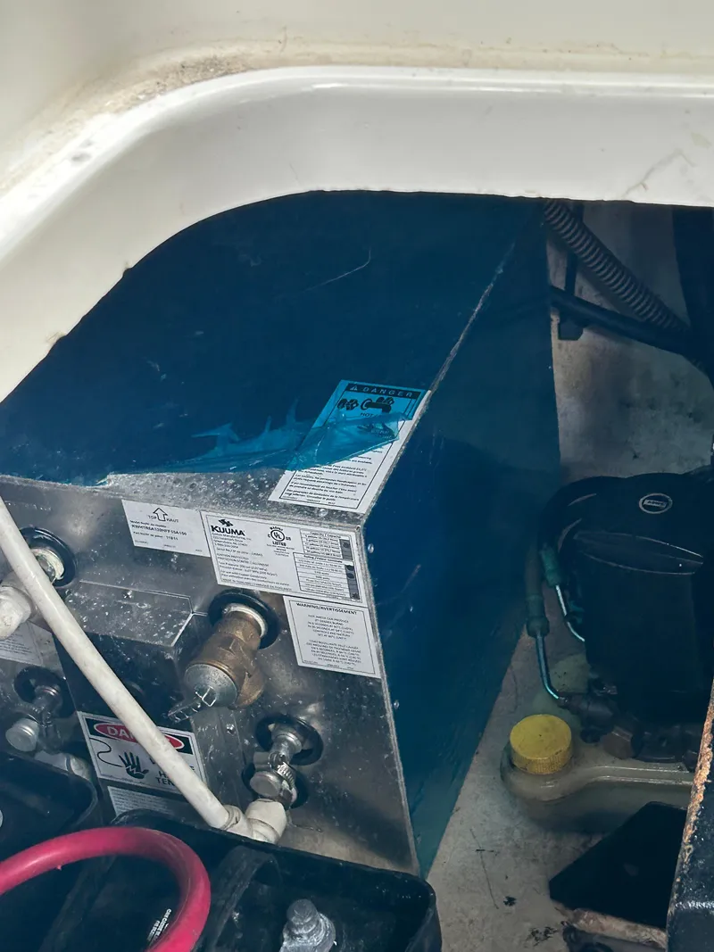 Slide: The Image of Engine compartment of a 2000 Formula 34 PC boat, showing mechanical components and wiring. - 26