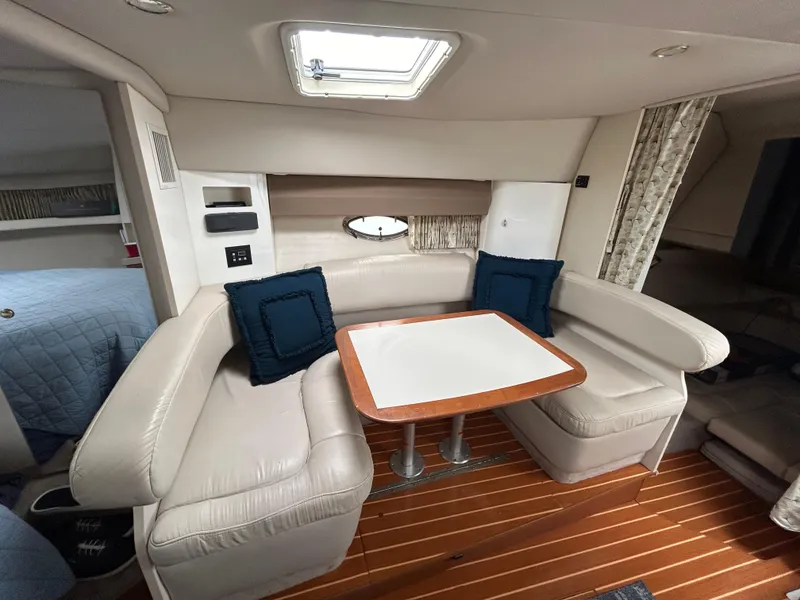 Slide: The Image of 2000 Formula 34 PC yacht interior with leather seating and wooden table. - 28
