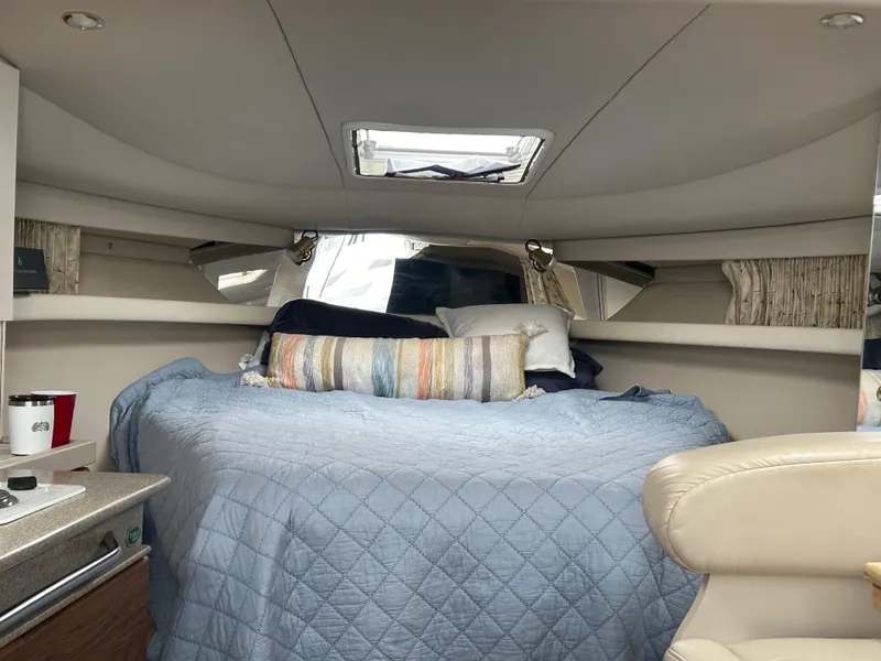 Slide: The Image of Interior cabin of a 2000 Formula 34 PC boat with a cozy bed setup. - 29