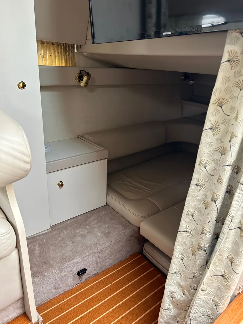 Slide: The Image of Interior cabin of a 2000 Formula 34 PC boat, featuring cozy seating and elegant decor. - 30