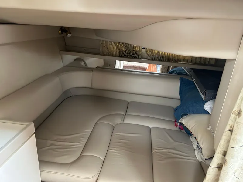 Slide: The Image of Interior cabin of 2000 Formula 34 PC boat with beige seating and bedding. - 31