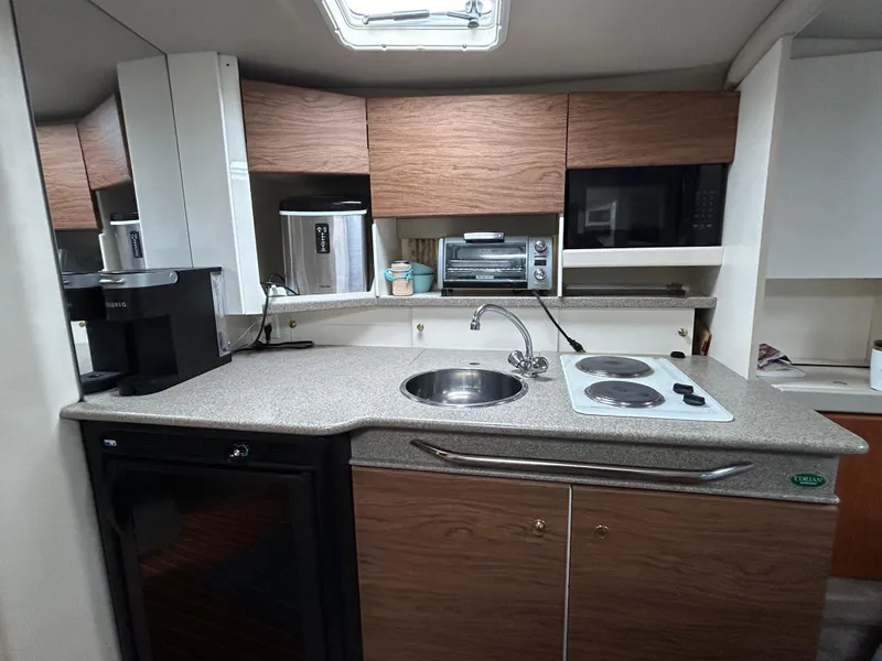 Slide: The Image of 2000 Formula 34 PC yacht kitchen with modern appliances and wood cabinetry. - 32