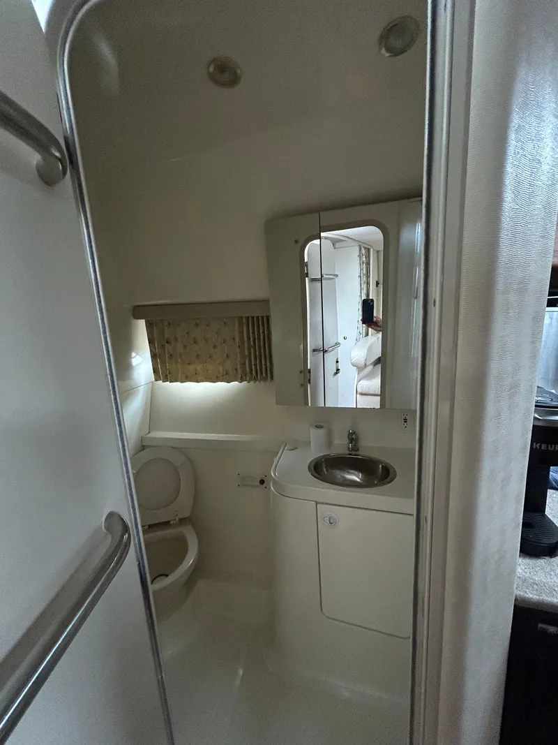 Slide: The Image of 2000 Formula 34 PC boat bathroom with sink, mirror, and toilet. - 34