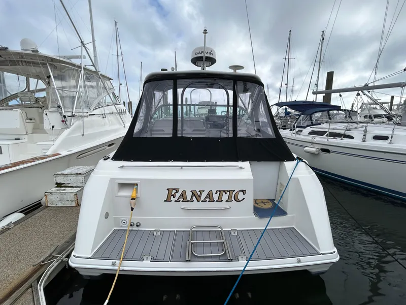 Slide: The Image of 2000 Formula 34 PC boat named "Fanatic" docked at a marina. - 4