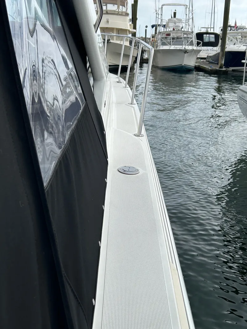 Slide: The Image of 2000 Formula 34 PC yacht docked at marina, side view with water reflection. - 8