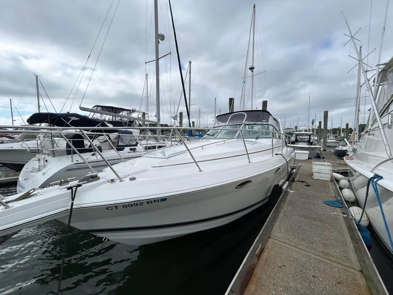 Slide: The Image of 2000 Formula 34 PC yacht docked at marina, overcast sky, surrounded by other boats. - 9