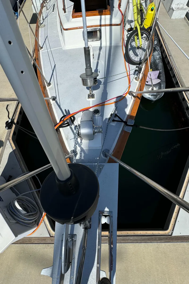 Slide: The Image of 1980 Ta Shing Mason 43 sailboat docked, view from mast, with bicycle on deck. - 3