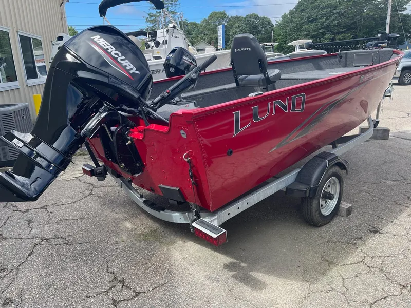 Slide: The Image of 2023 Lund 1650 Angler Tiller boat with Mercury outboard motor on trailer. - 2