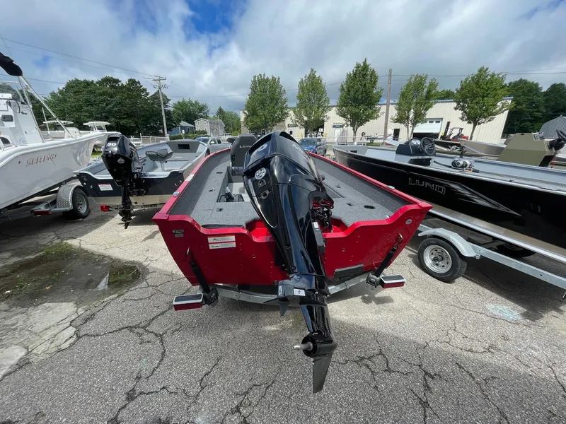 Slide: The Image of 2023 Lund 1650 Angler Tiller boat with outboard motor, parked on a trailer. - 3