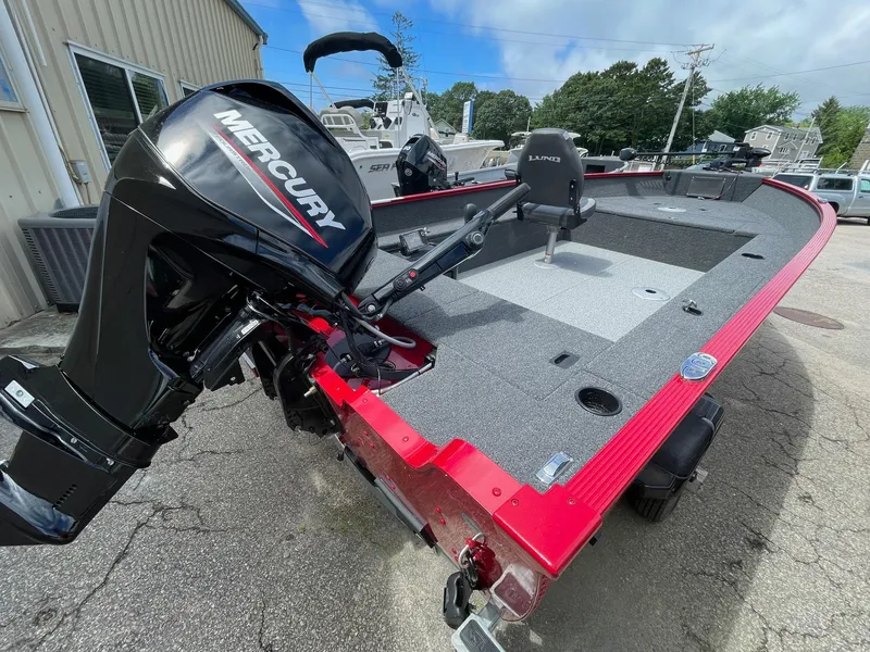 Slide: The Image of 2023 Lund 1650 Angler Tiller boat with Mercury outboard motor, red and gray color scheme. - 4