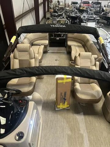 Slide: The Image of 2025 Veranda VR25RC pontoon boat interior with Yamaha 250 SHO engine, beige seating, and helm station. - 16