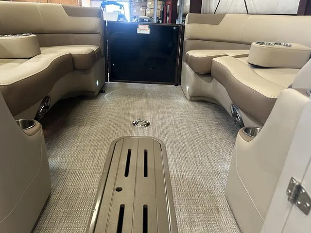 Slide: The Image of Interior of 2025 Veranda VR25RC pontoon boat with beige seating and carpeted floor. - 29