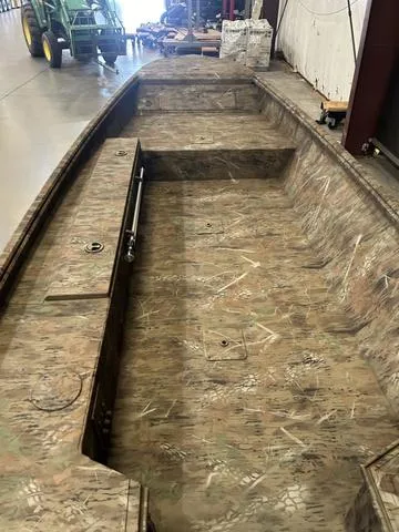 Slide: The Image of 2025 G3 16DK boat interior with camouflage design in a warehouse. - 6