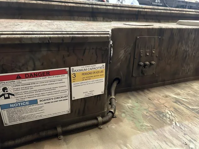 Slide: The Image of Close-up of a 2025 G3 16DK boat's control panel and safety labels. - 8