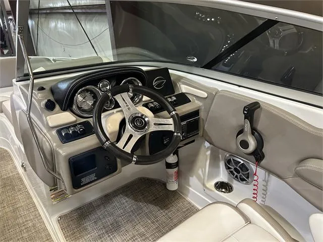 Slide: The Image of 2018 Crownline E21X boat cockpit with steering wheel and control panel. - 11