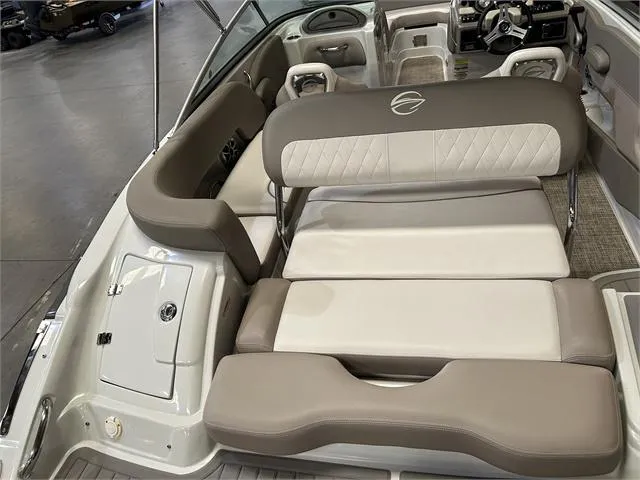 Slide: The Image of 2018 Crownline E21X boat interior with beige and white seating. - 18