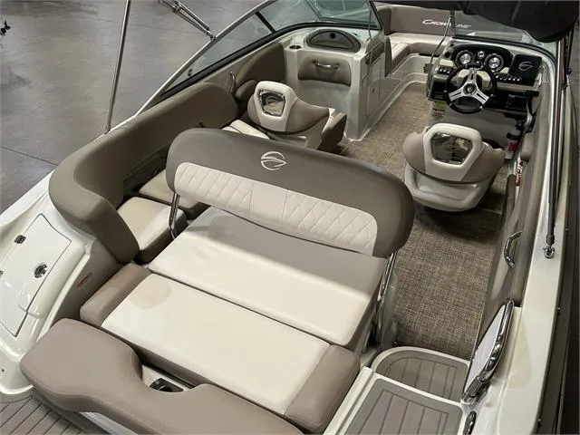 Slide: The Image of 2018 Crownline E21X boat interior with beige seating and modern dashboard. - 19