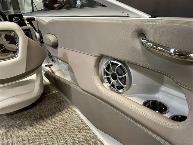 Slide: The Image of Interior of a 2018 Crownline E21X boat showing speaker and cup holders. - 20