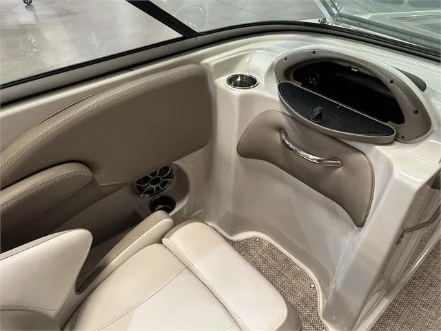 Slide: The Image of Interior of 2018 Crownline E21X boat with beige seating and storage compartment. - 22