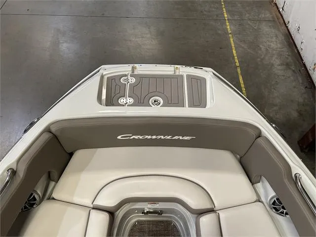 Slide: The Image of 2018 Crownline E21X boat interior with cushioned seating and storage compartments. - 23