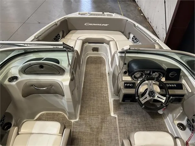 Slide: The Image of 2018 Crownline E21X boat interior with steering wheel and seating. - 7