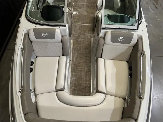 Slide: The Image of 2018 Crownline E21X boat interior with beige and gray seating. - 9