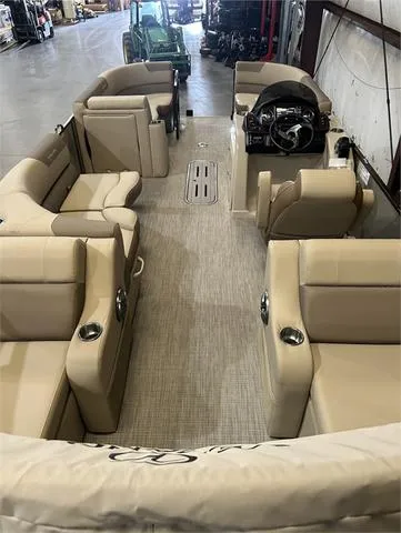 Slide: The Image of 2024 Veranda VR22RFL boat interior with beige seating and steering console. - 20