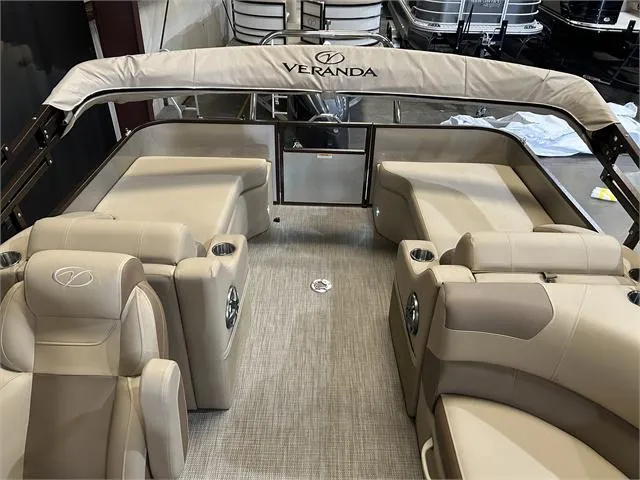 Slide: The Image of 2024 Veranda VR22RFL boat interior with beige seating and canopy. - 21