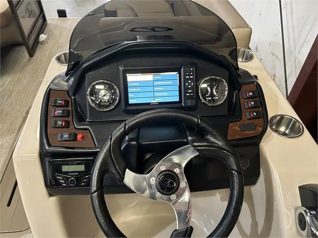 Slide: The Image of 2024 Veranda VR22RFL boat dashboard with steering wheel and control panel. - 23
