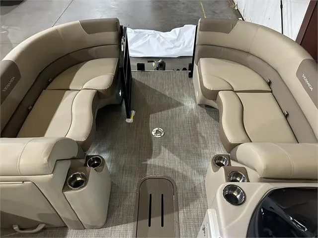 Slide: The Image of 2024 Veranda VR22RFL W/Yamaha 150 pontoon boat interior with beige seating and cup holders. - 10